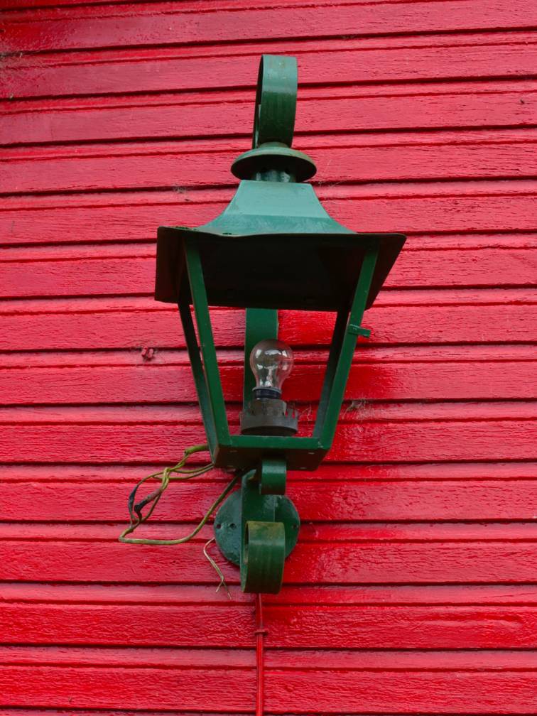 Green Color External Lamp on Red Wall