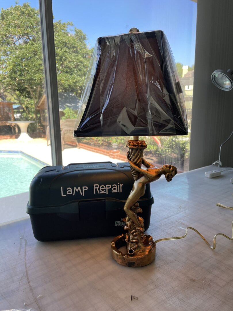 a lamp and a lamp repair tool box on the table