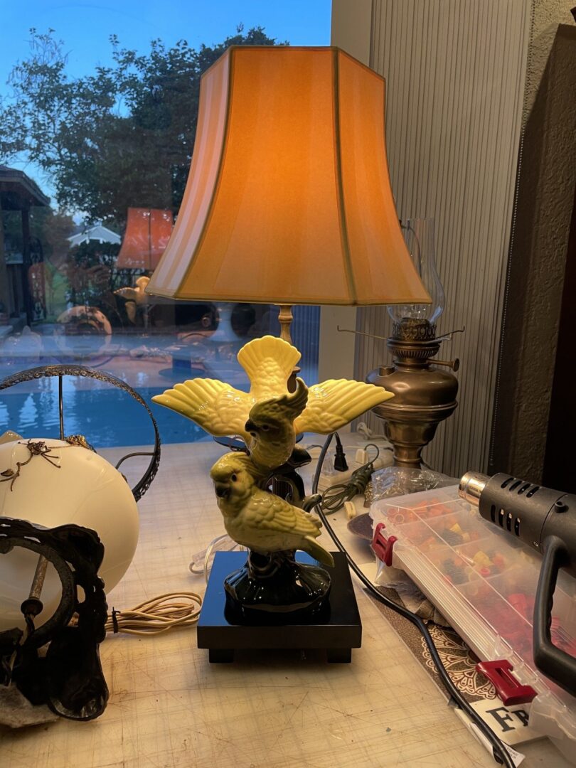closeup shot of a lamp with birds statue